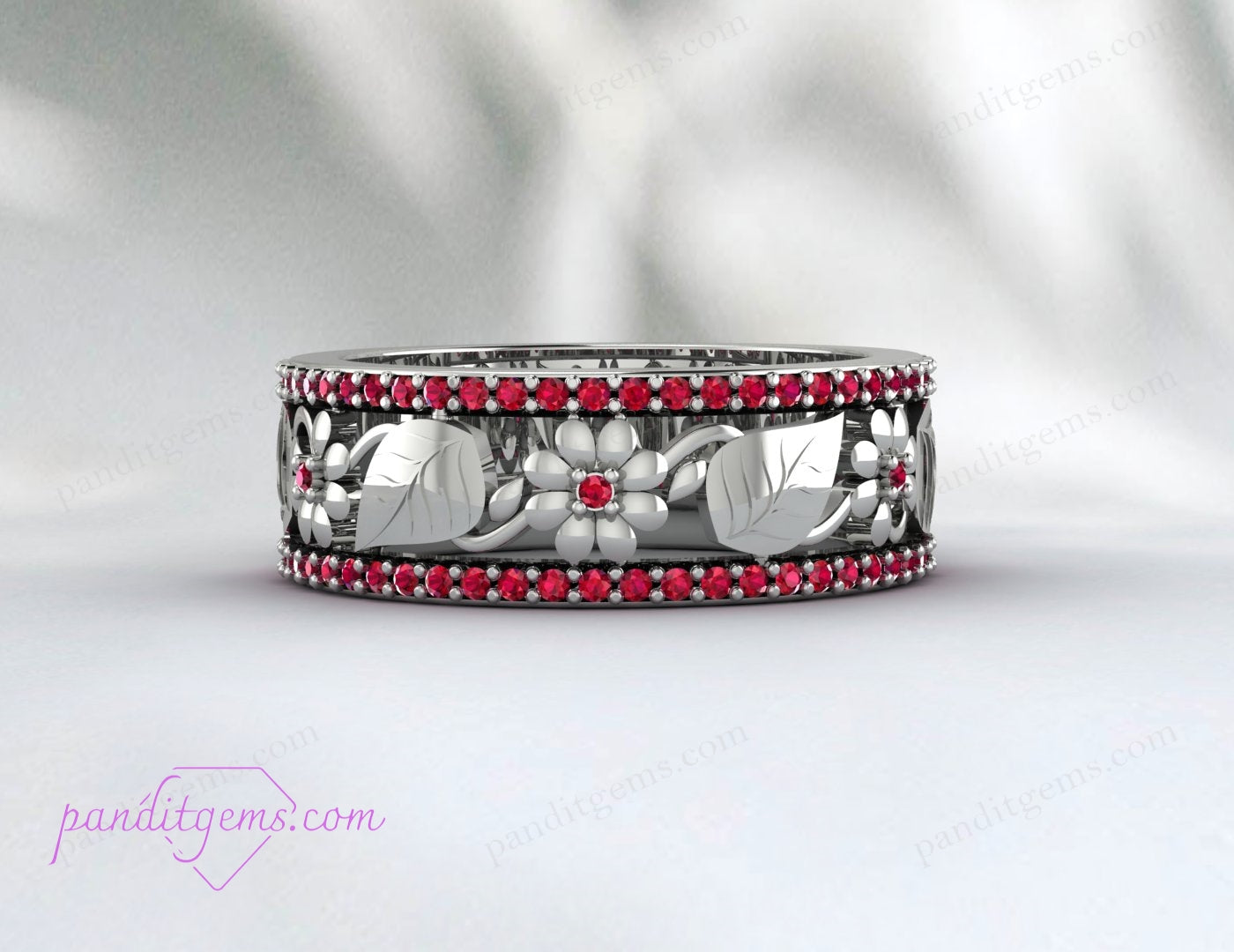 The Rose Gold Ruby Leaf Wedding Band is displayed against a white background, highlighting its detailed craftsmanship and vibrant ruby gemstone.