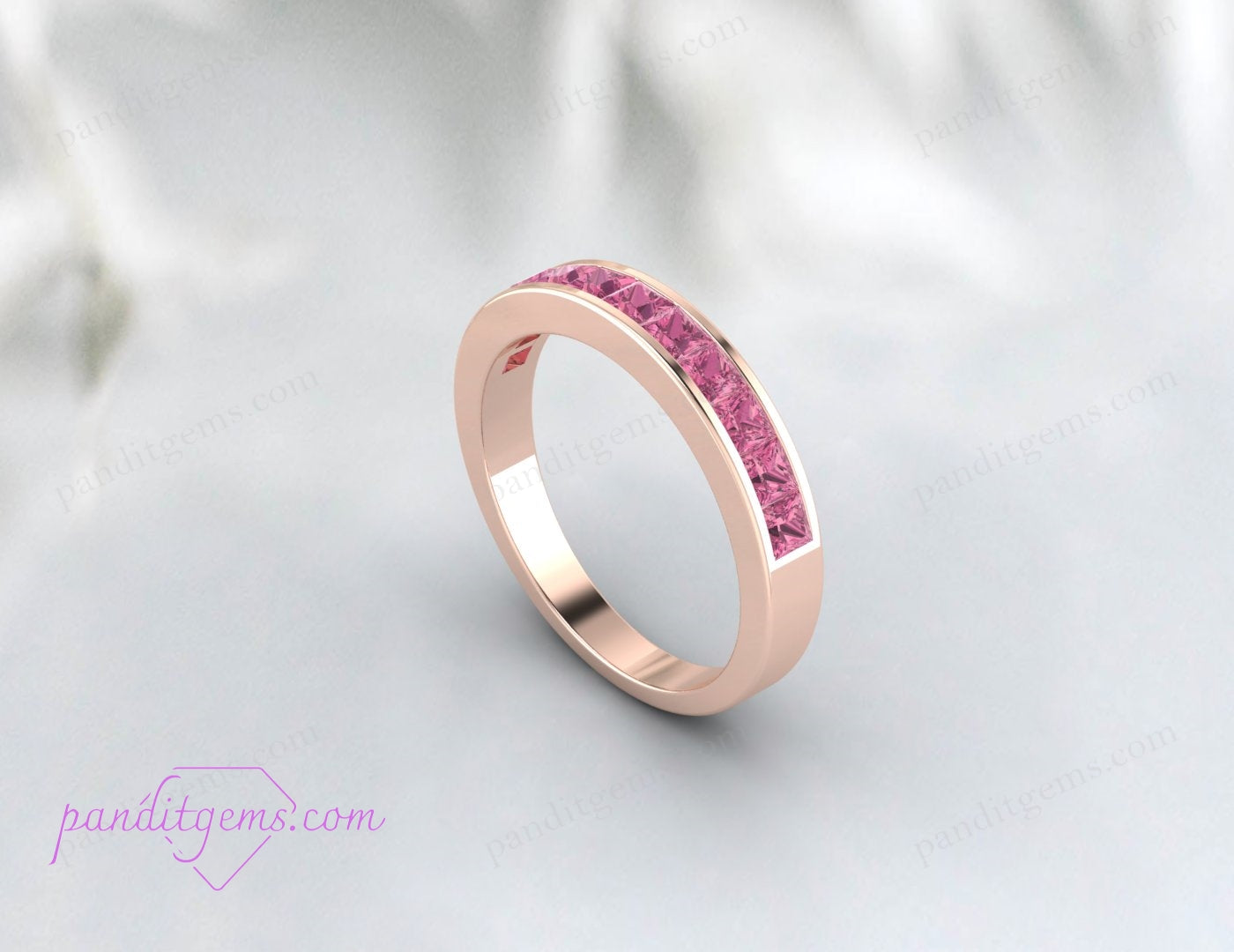Rose gold eternity ring with princess cut pink gemstones.
