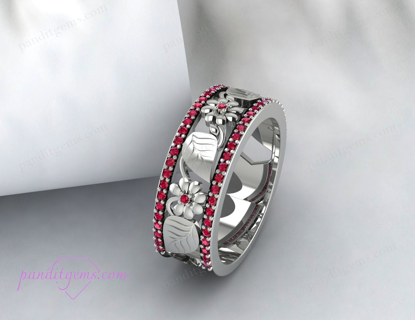 The wedding band is set against a floral background, emphasizing its nature-inspired design.