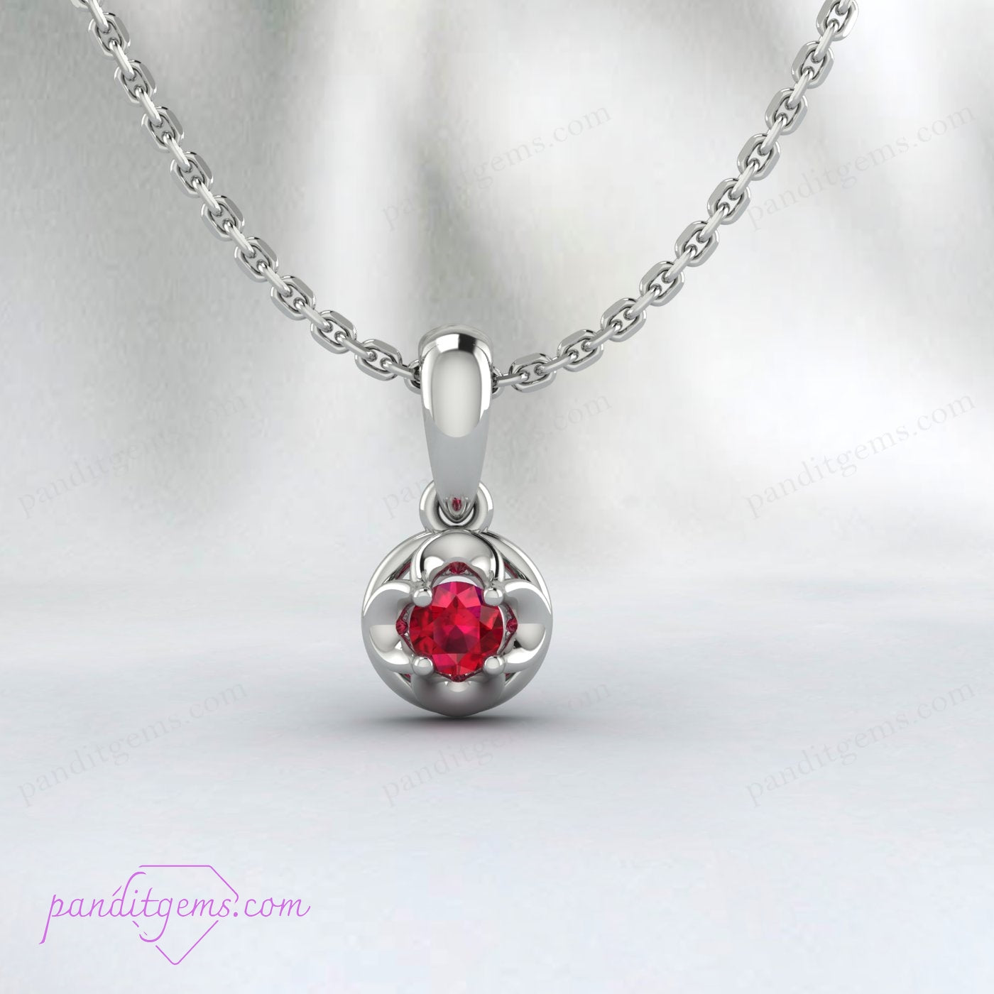 Detailed image of the ruby pendant with a prong setting in 18K gold filled metal.