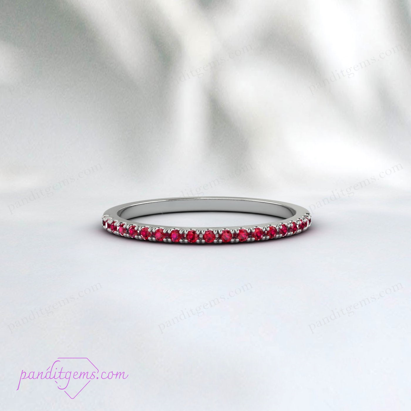 A rose gold band with a half eternity setting of 1.5mm natural rubies.