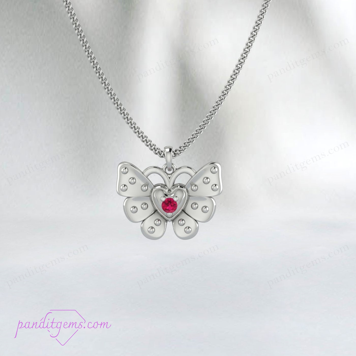 Ruby butterfly pendant showcased on a model’s neckline.