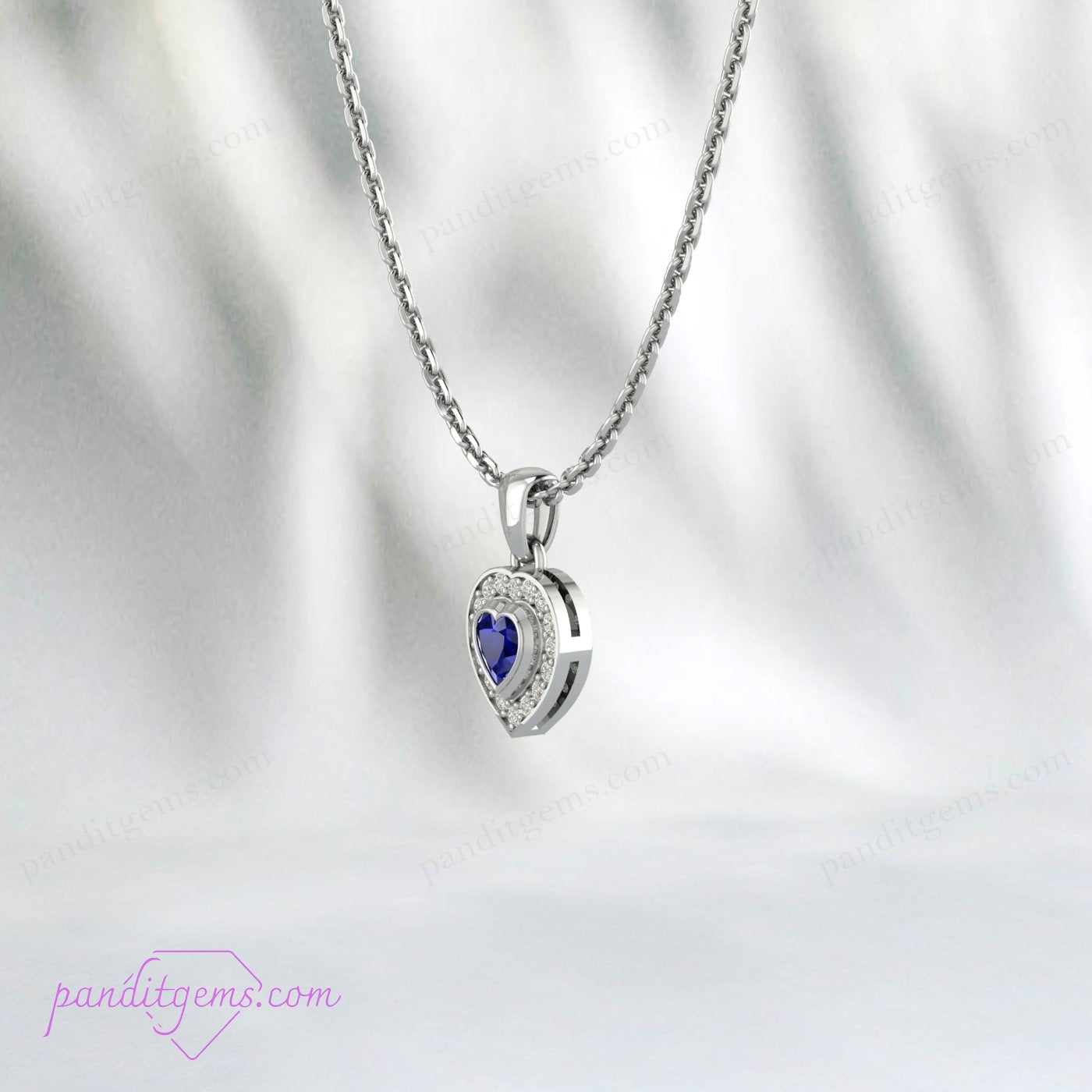 Side profile of heart-shaped sapphire pendant in sterling silver with CZ halo.