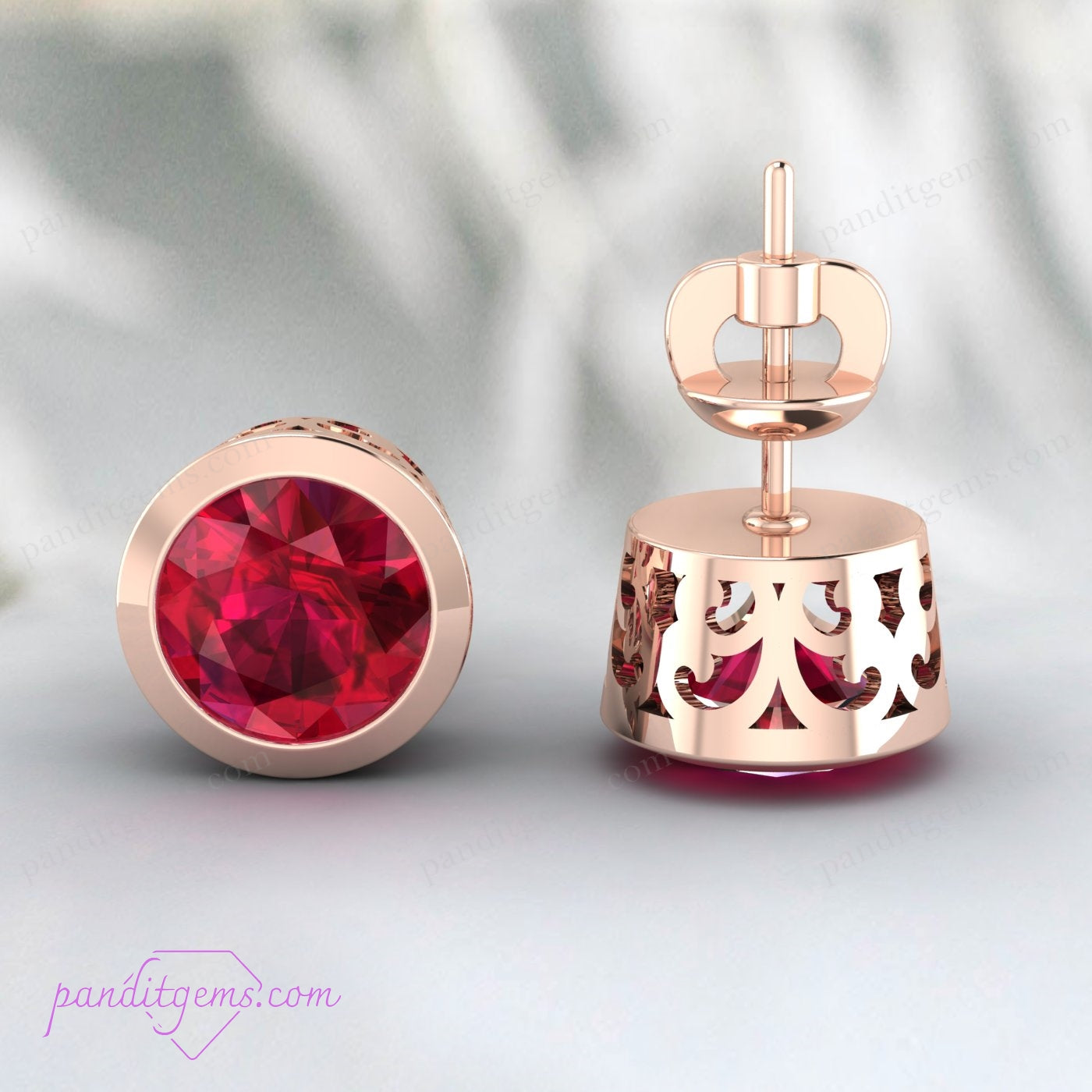 Side view of ruby stud earrings with a filigree pattern in gold-filled setting.