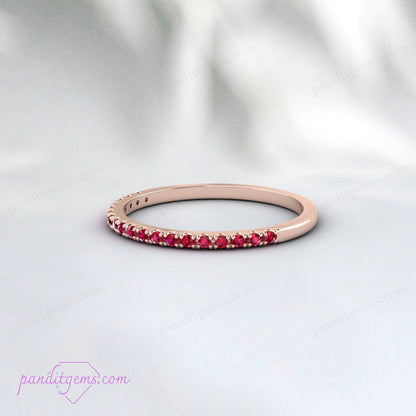 Multiple ruby wedding bands stacked together.