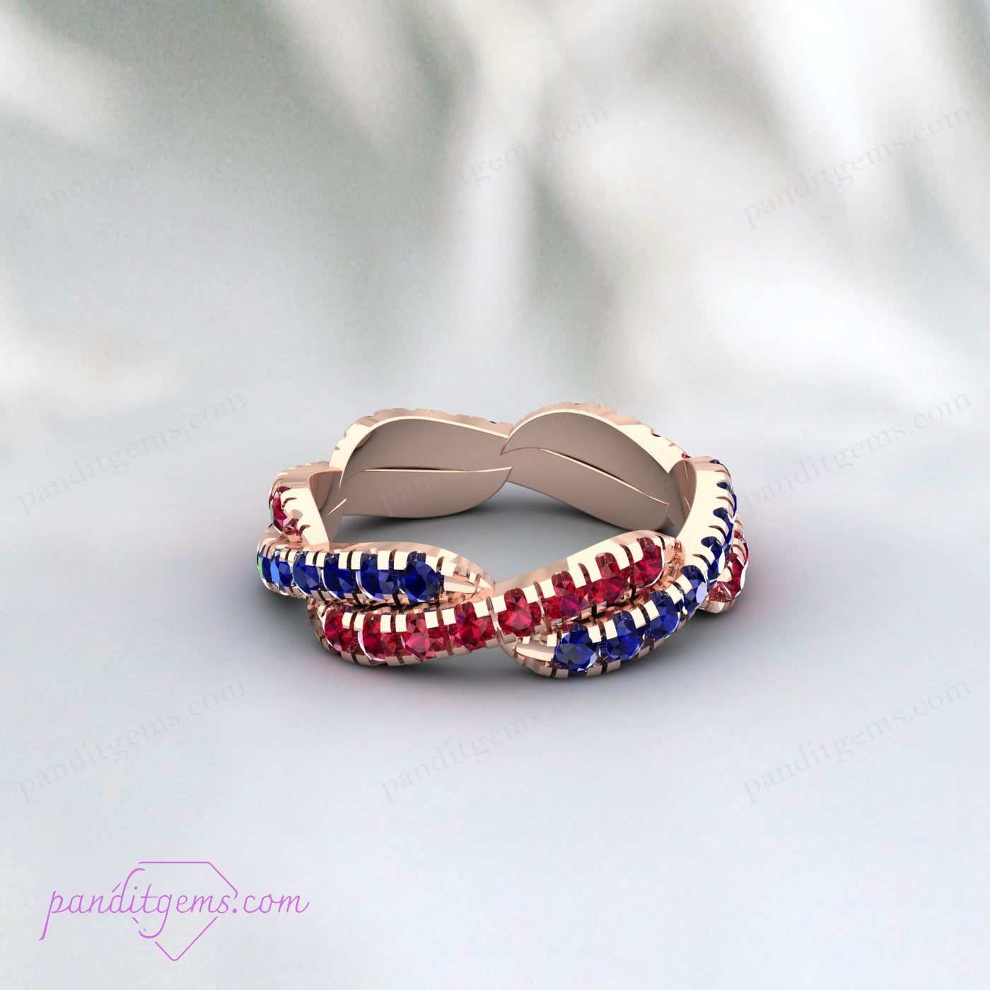 Sterling Silver Blue Sapphire and Ruby Ring with infinity twist design, a meaningful birthstone ring for September and July.