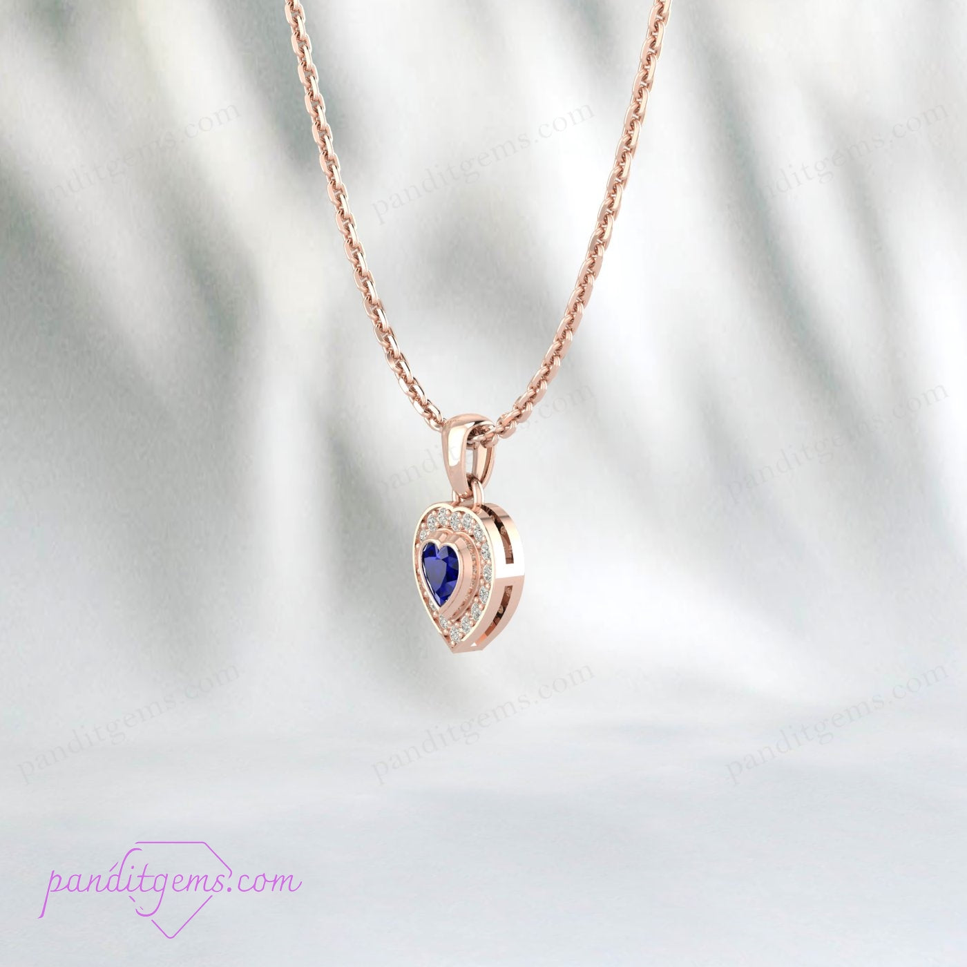 Sterling silver heart-shaped blue sapphire pendant surrounded by sparkling CZ halo.