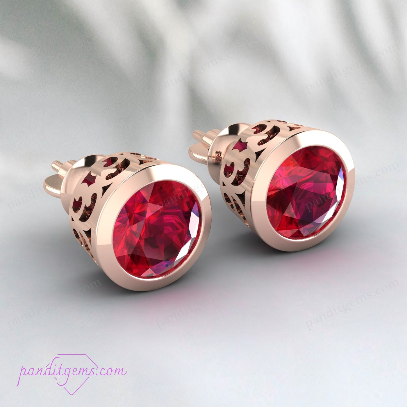 Sterling silver ruby stud earrings with screwback closure for secure wear.