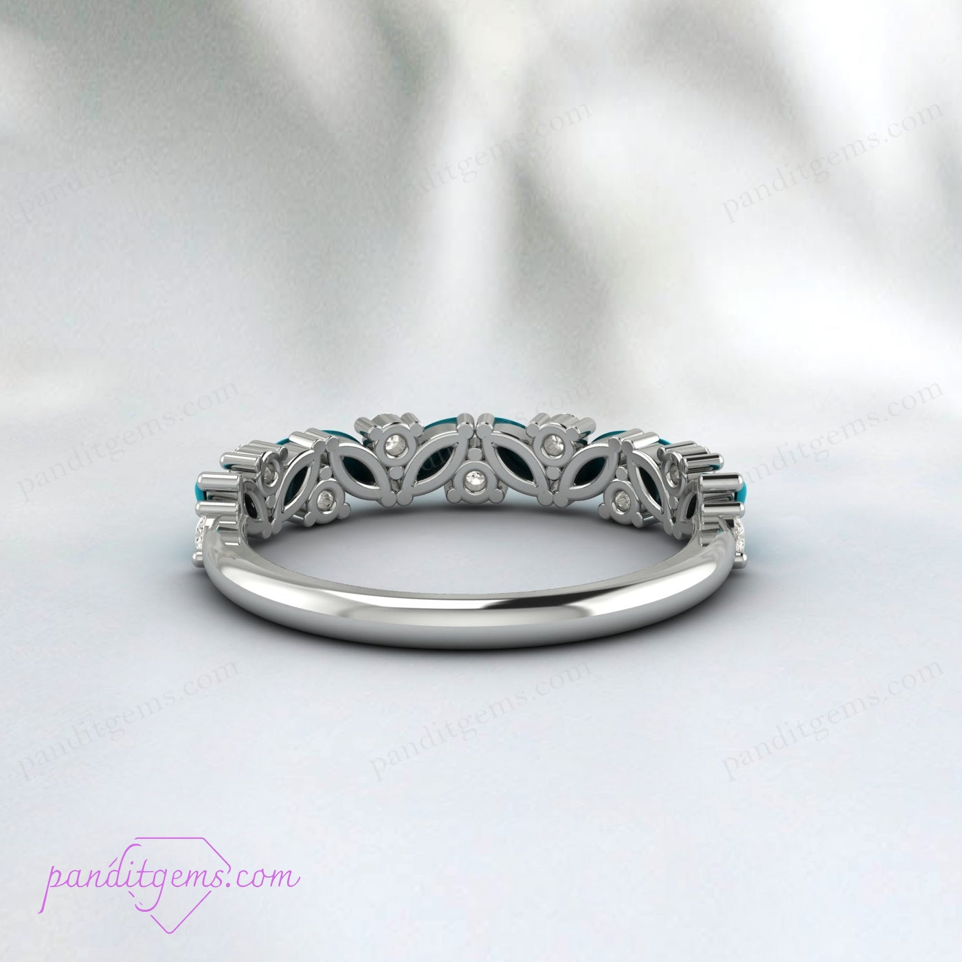 A sterling silver turquoise ring adorned with Greek key patterns and white cubic zirconia stones