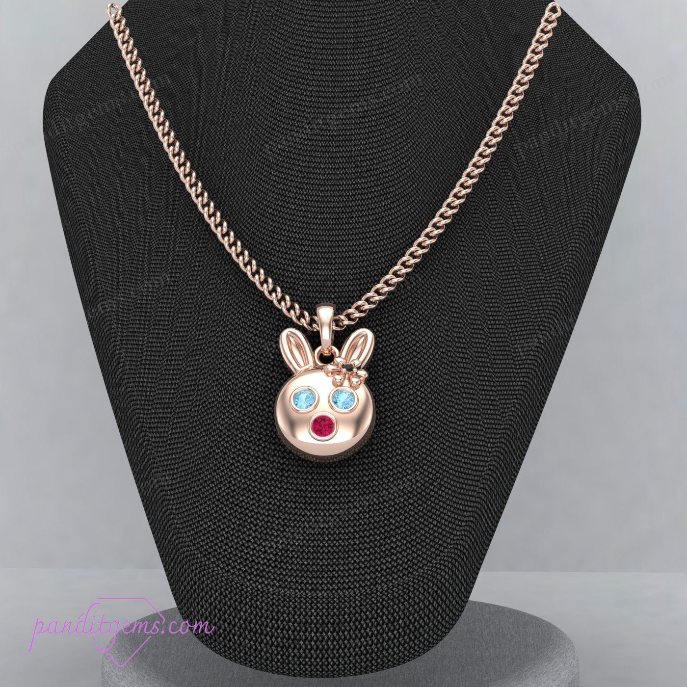 Tiny rabbit pendant with Aquamarine, Ruby, and Onyx, handcrafted in sterling silver with delicate gold details.