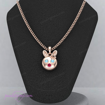 Tiny rabbit pendant with Aquamarine, Ruby, and Onyx, handcrafted in sterling silver with delicate gold details.