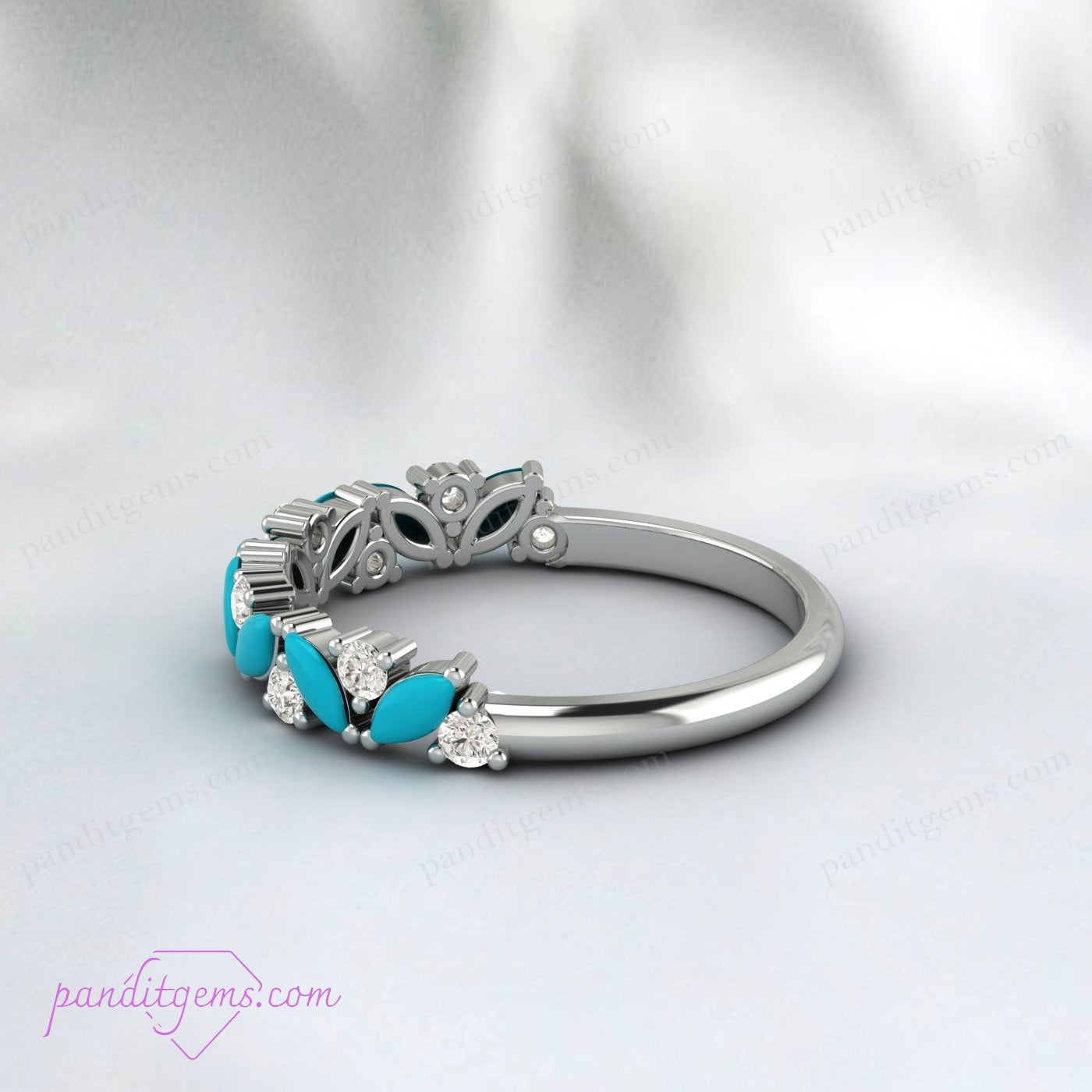 A unique turquoise wedding band featuring a marquise cut stone and round cubic zirconia