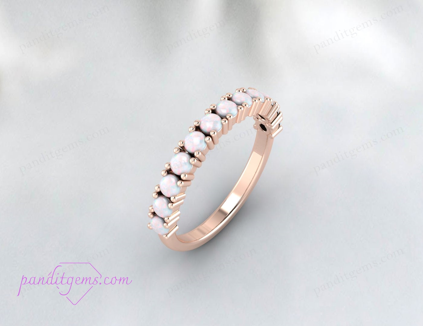Vibrant opal wedding band shown in rose gold with half-eternity setting.

