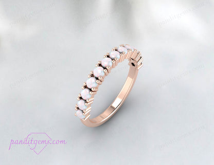 Vibrant opal wedding band shown in rose gold with half-eternity setting.
