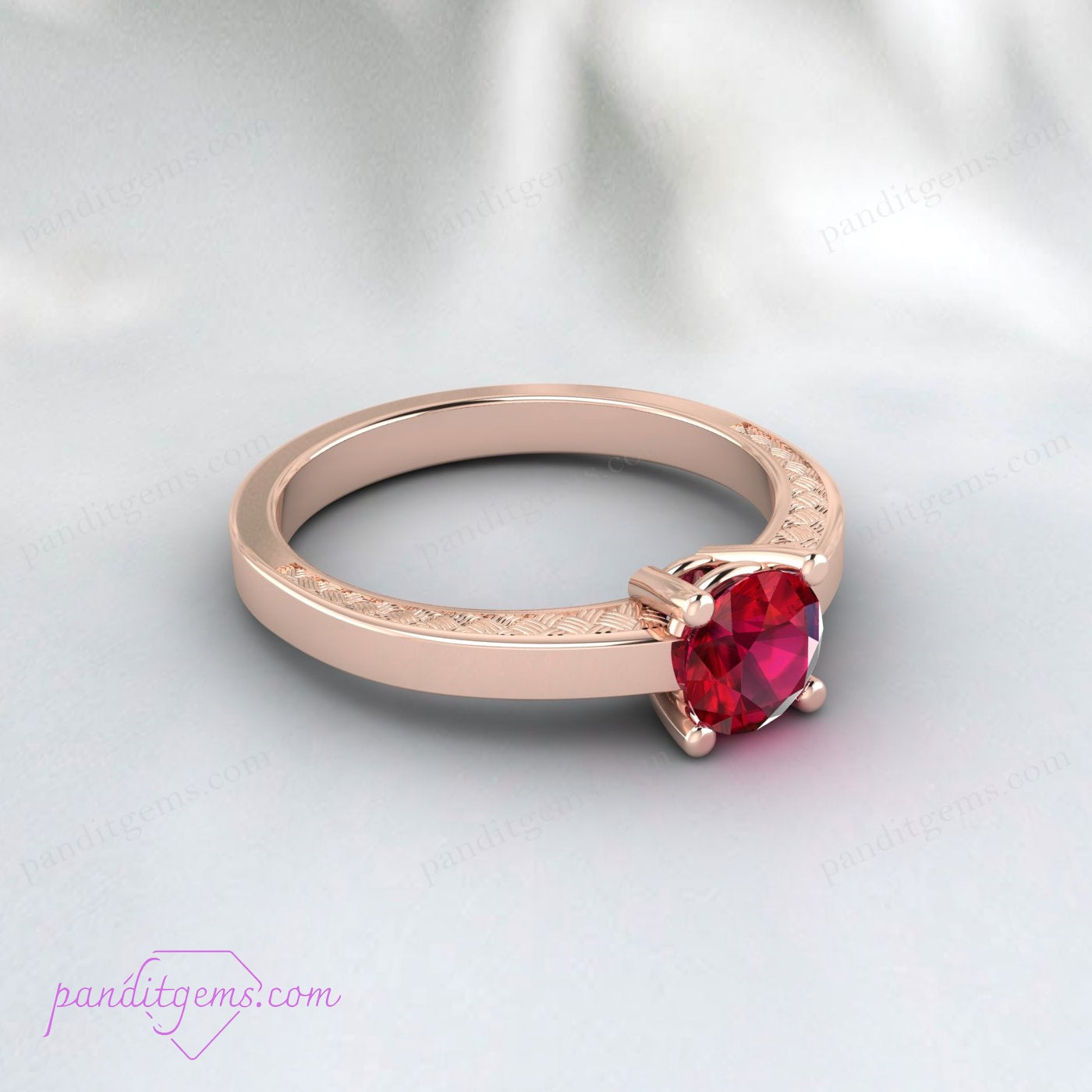 Victorian-style ruby engagement ring with gold-filled floral pattern band.