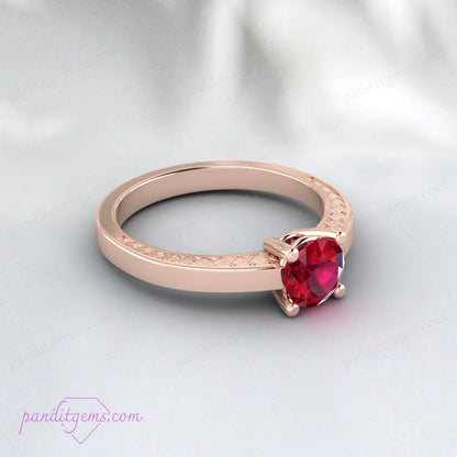 Victorian-style ruby engagement ring with gold-filled floral pattern band.