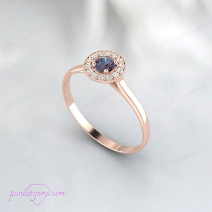 A vintage-inspired engagement ring featuring Alexandrite with a surrounding halo in rose gold.