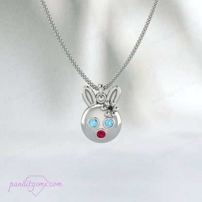 Whimsical bunny charm necklace featuring Aquamarine, Ruby, and Onyx, in sterling silver with gold accents.