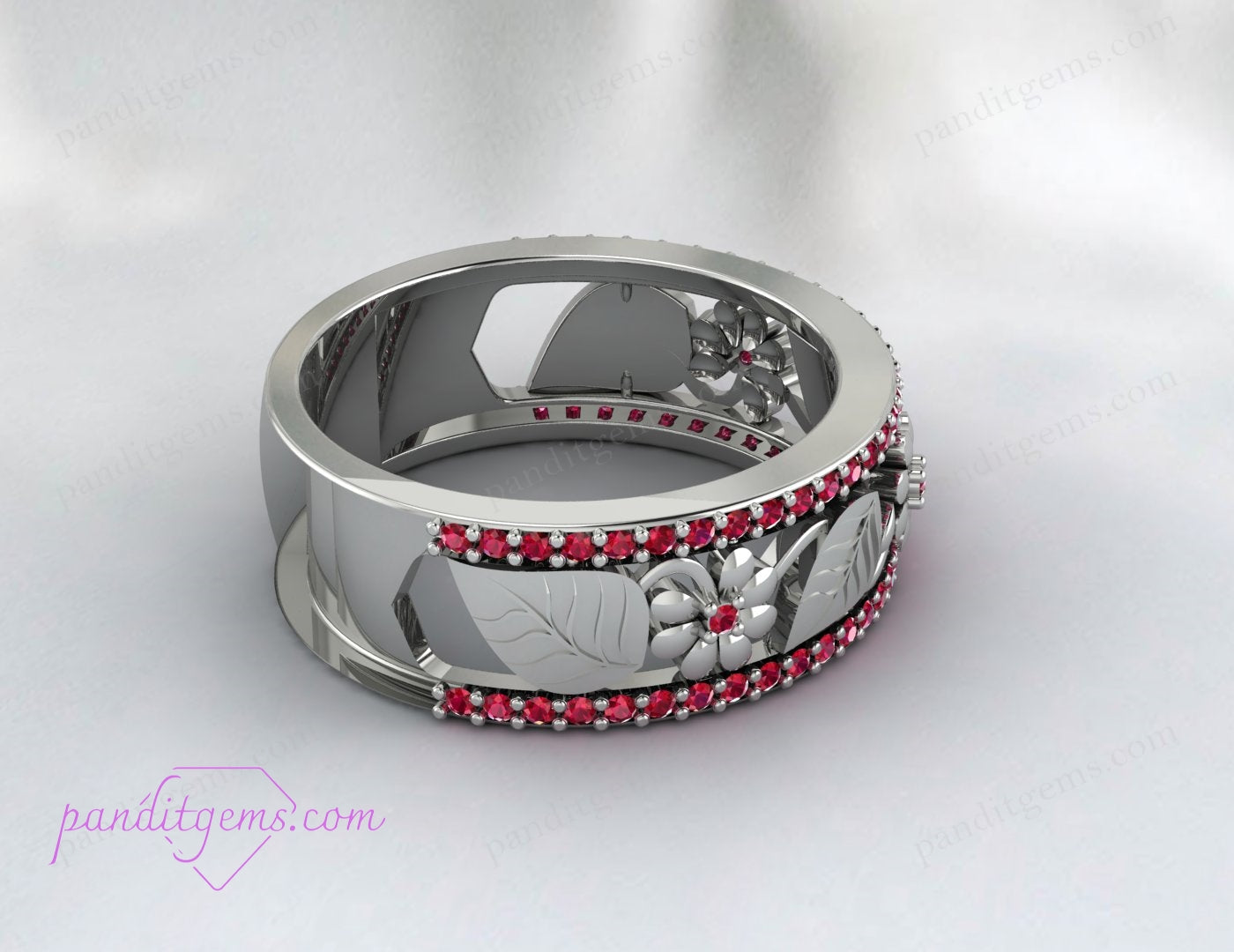 A woman's hand adorned with the Rose Gold Ruby Leaf Wedding Band, illustrating its fit and style.