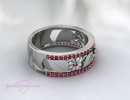A woman's hand adorned with the Rose Gold Ruby Leaf Wedding Band, illustrating its fit and style.