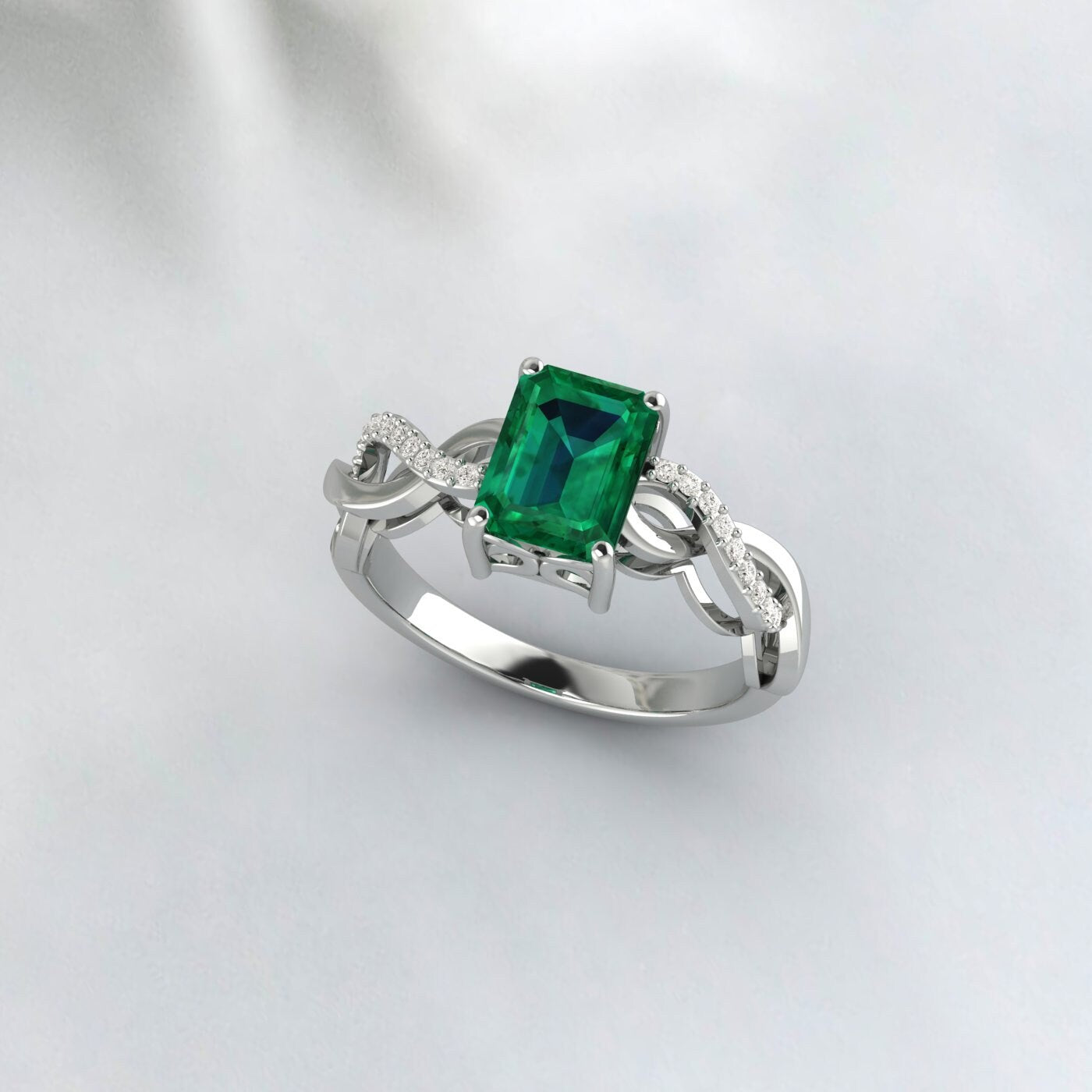 Bague de demande en mariage solitaire taille émeraude torsadée infini en argent et émeraude