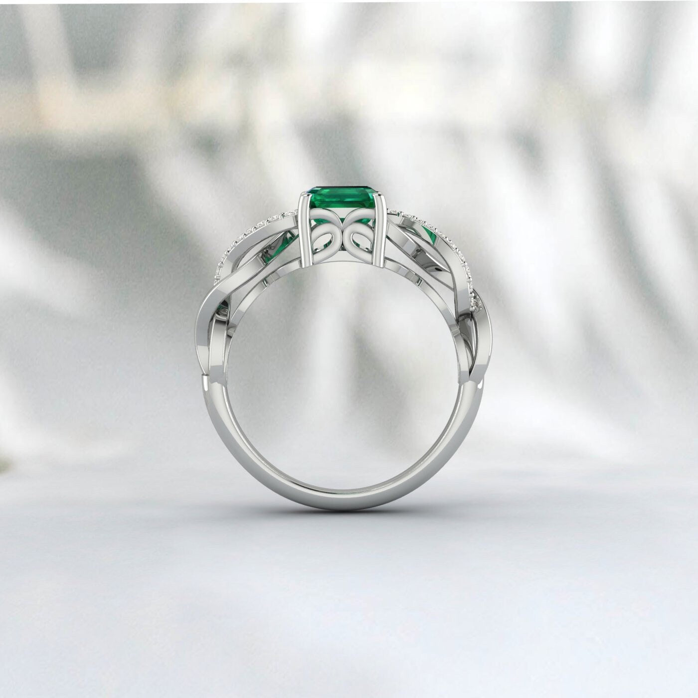 Bague de demande en mariage solitaire taille émeraude torsadée infini en argent et émeraude